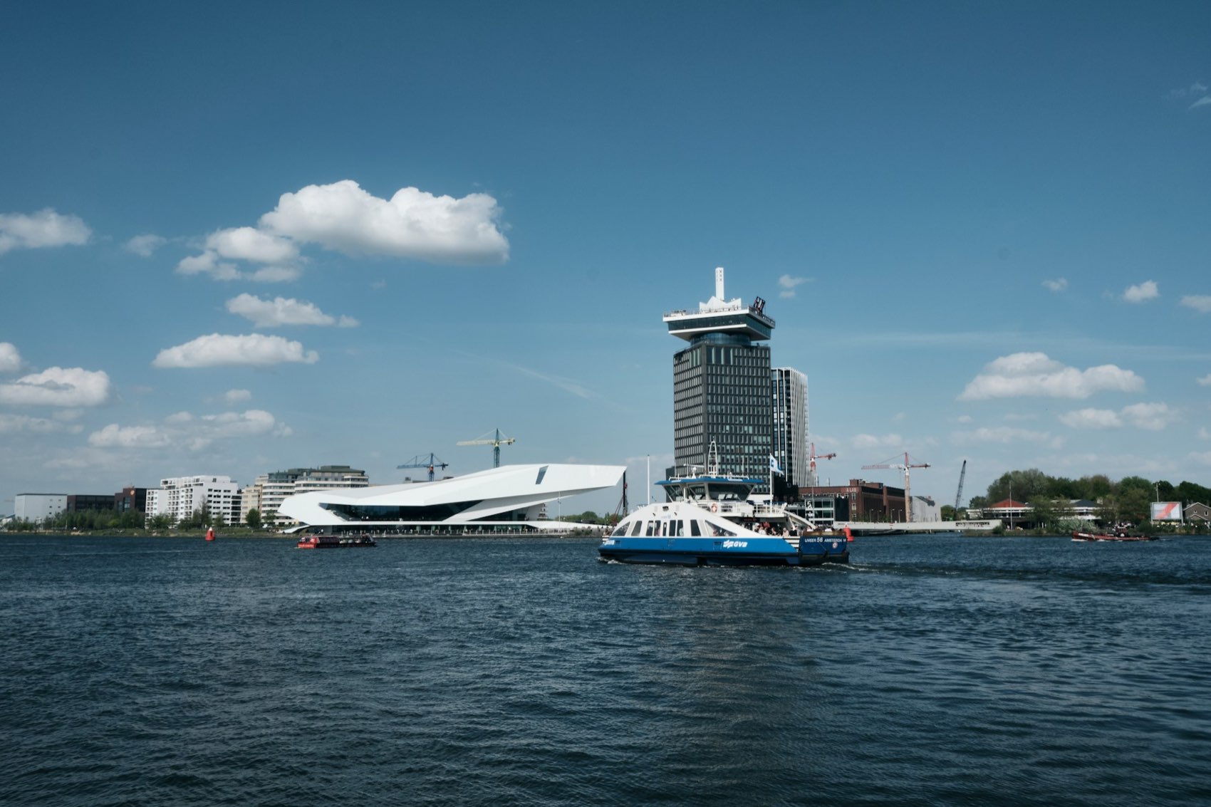 The IJ waterfront in Amsterdam with Eye Filmmuseum on the north bank and a ferry crossing